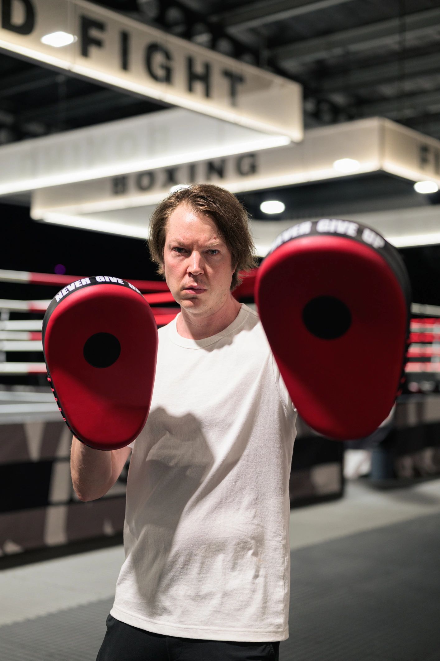 Boxing trainer holding focus mitts